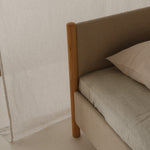 Minimalistisch houten bedframe, ontworpen door Rye Sleep en verkrijgbaar bij By Mölle. Met strakke Scandinavische lijnen, een laag silhouet en een zacht gestoffeerd hoofdbord combineert dit bed tijdloos design met natuurlijke materialen voor een rustige, moderne slaapkamer.