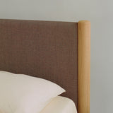 Minimalist wooden bed frame designed by Rye Sleep and available at By Mölle. Featuring clean Scandinavian lines, a low-profile form, and a softly upholstered headboard, this bed blends timeless design with natural materials for a calm, modern bedroom atmosphere