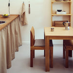 Square table with ultra-slim tabletop and recessed legs made of solid oak. A subtle shadow line between the top and frame creates a light floating effect. Modular design allows multiple tables to connect seamlessly in a row. Durable and elegant, ideal for everyday use in contemporary interiors.