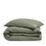 By Mölle's olive linen duvet cover, crafted from 100% pre-washed European flax linen, features a soft green hue inspired by olive tree leaves. This breathable and hypoallergenic fabric offers comfort year-round and is available with either wooden buttons or a tuck-in flap closure.