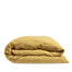 By Mölle's honey linen duvet cover, crafted from 100% pre-washed European flax linen, features a warm, faded yellow tone that adds softness to your home. The breathable and hypoallergenic fabric provides comfort year-round and is available with either wooden buttons or a tuck-in flap closure.