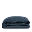 By Mölle's indigo linen duvet cover, crafted from 100% pre-washed European flax linen, features a deep indigo blue hue. The breathable and hypoallergenic fabric provides comfort year-round and is available with either wooden buttons or a tuck-in flap closure.