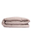 By Mölle's Pink Salt linen duvet cover, crafted from 100% pre-washed European flax linen, features a chambray weave combining pink and off-white threads. This warm pink hue adds a soft touch to any bedroom. The duvet cover is available with either wooden buttons or a tuck-in flap closure.