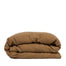 By Mölle's cinnamon linen duvet cover, crafted from 100% pre-washed European flax linen, features a rich, earthy tone that adds character to your bedroom. The breathable and hypoallergenic fabric offers comfort year-round and is available with either wooden buttons or a full-width tuck-in flap closure.