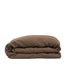 By Mölle's cocoa linen duvet cover, crafted from 100% pre-washed European flax linen, features a warm, deep brown shade. The breathable and hypoallergenic fabric provides comfort year-round and is available with either wooden buttons or a tuck-in flap closure.