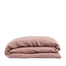 By Mölle's coral linen duvet cover made from 100% pre-washed European flax linen, featuring a soft, breathable fabric with a natural texture and a choice of wooden buttons or tuck-in flap closure