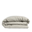 By Mölle's Flax linen duvet cover, crafted from 100% pre-washed European flax linen, features a natural, earthy tone achieved through chambray weaving with flax and off-white yarns. This breathable and hypoallergenic fabric offers comfort year-round and is available with either wooden buttons or a full-width tuck-in flap closure. Handmade in the Netherlands with respect for the earth.