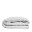 By Mölle's Misty Grey linen duvet cover, crafted from 100% pre-washed European flax linen, features a versatile light grey shade with a subtle blue undertone. The chambray weave combines light grey and off-white yarns, adding depth and character to the fabric. This breathable and hypoallergenic linen offers comfort year-round and is available with either wooden buttons or a full-width tuck-in flap closure. Handmade in the Netherlands with respect for the earth.