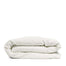 By Mölle's Warm White linen duvet cover, crafted from 100% pre-washed European flax linen, features a pure tone with a touch of cream. The high-quality chambray weave adds depth and character. Available with wooden buttons or a full-width tuck-in flap closure, this breathable and hypoallergenic fabric offers year-round comfort.