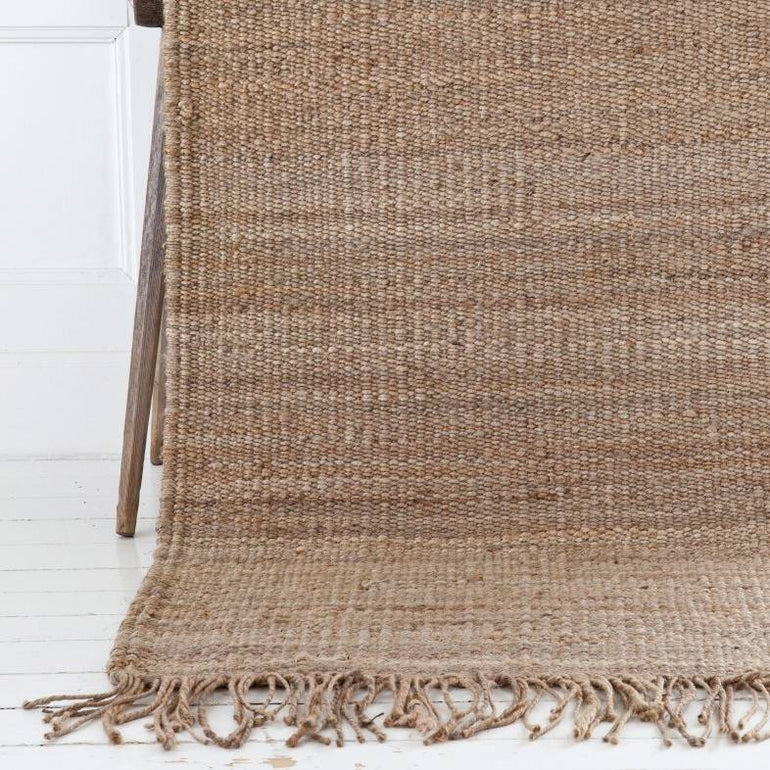 Handwoven natural hemp rug By Mölle with fringes.
